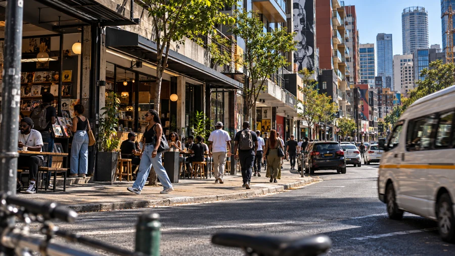 Cafés, shopfronts and pedestrians along Braamfontein high street